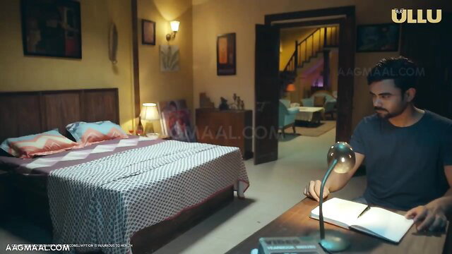Indian man in bedroom writing at desk in Tamil erotica scene