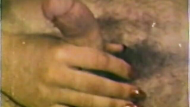 Closeup of hand stroking erect penis in classic Pretty Girls 112 April porn