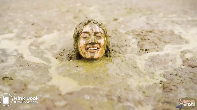 Rada Brewer sexy smiling face in wet manure mud pit fetish