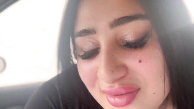Arab beauty with thick lips seduces in car, glossy makeup closeup