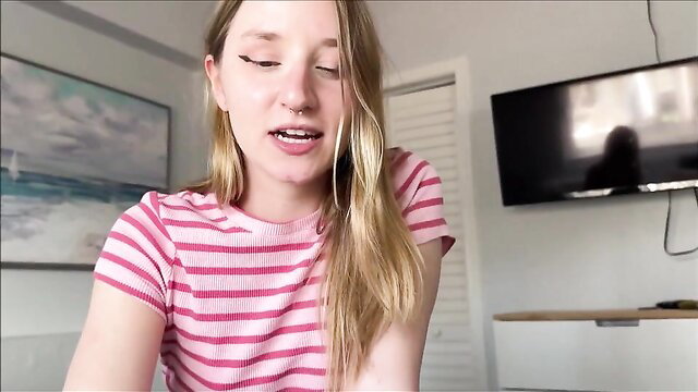 Gorgeous blonde teen seductress in pink striped top, teasing smile