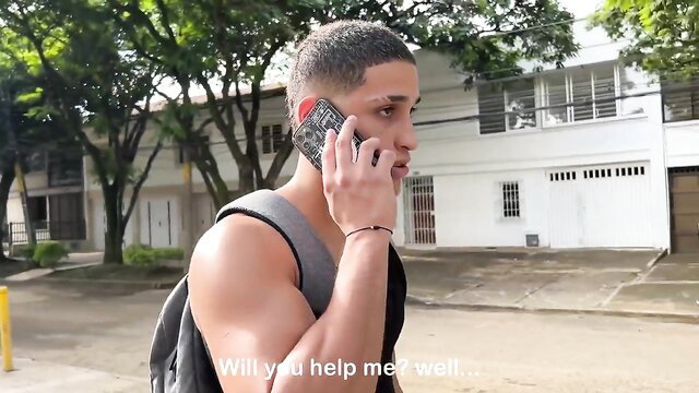 Muscular Latino hunk Sarah Black on phone, tank top curves outdoors
