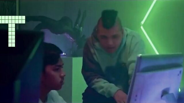 Asian woman and mohawk guy at neon-lit computer in Taya Vivamax video