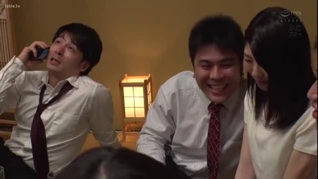 Japanese office workers laughing with wife Miyuki Hasaka at company party