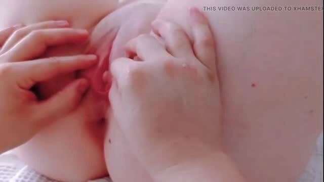 Closeup hands spreading shaved pussy lips wide open, first time dilation