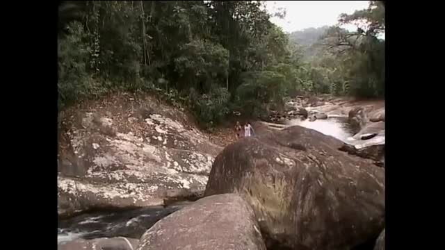 Outdoor sex scene by river with couple on rocks in jungle