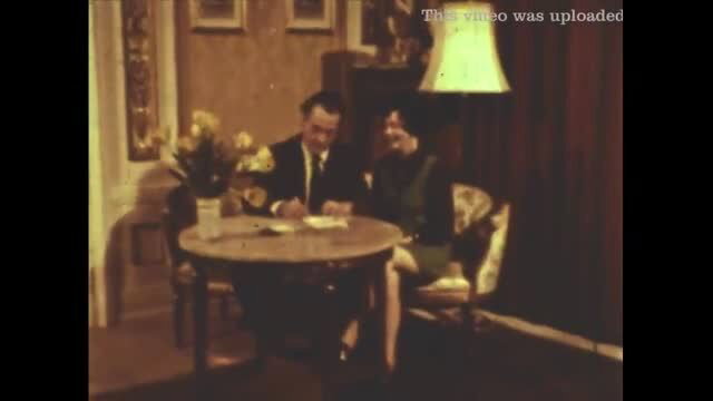 Vintage couple at table in 1970s retro porn scene