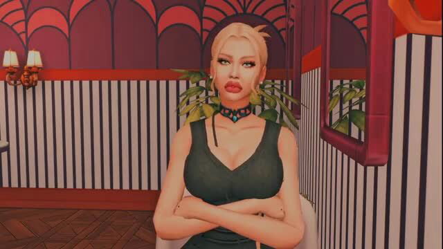 Blonde woman in green dress with arms crossed, looking seductive