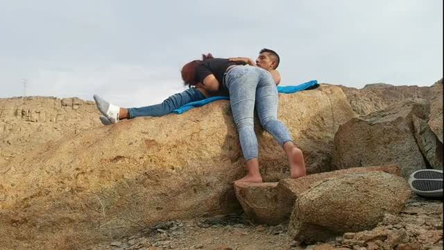 Couple outdoor anal sex on rocks, jeans pulled down, picnic sex
