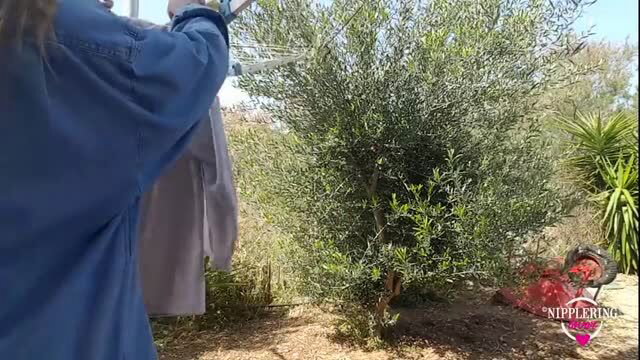 Horny MILF with pierced pussy outdoors near olive tree