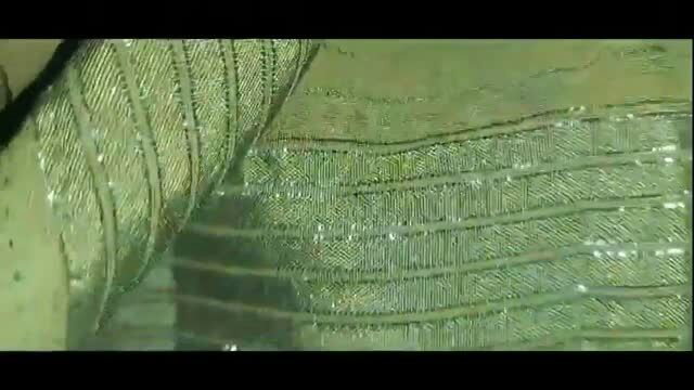 Close-up of sheer green lace lingerie with sparkling embellishments