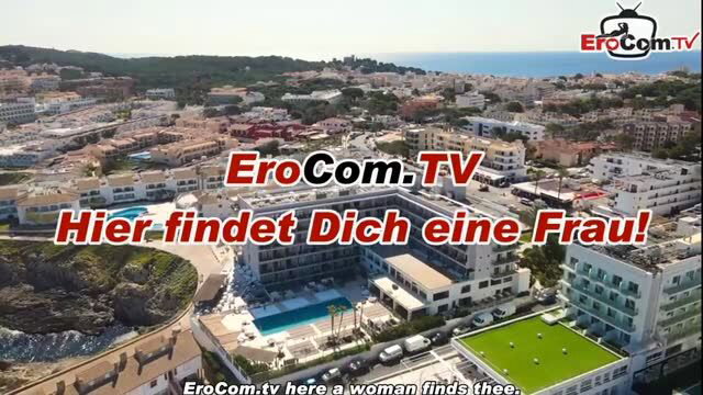 Aerial view of coastal resort hotel promoting EroCom.TV dating service