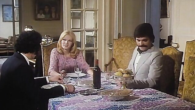 Vintage French adult film dinner scene with slim busty blonde and two men