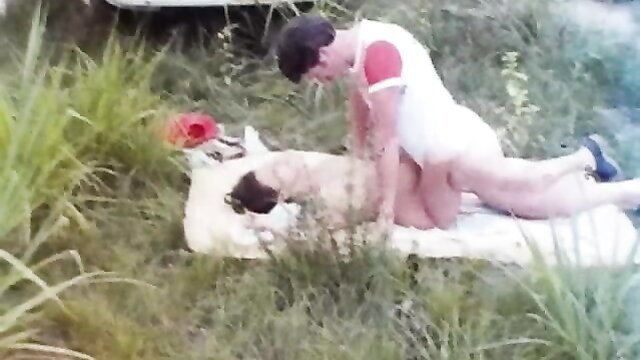 Vintage busty nurse rides cock outdoors doggystyle on grass