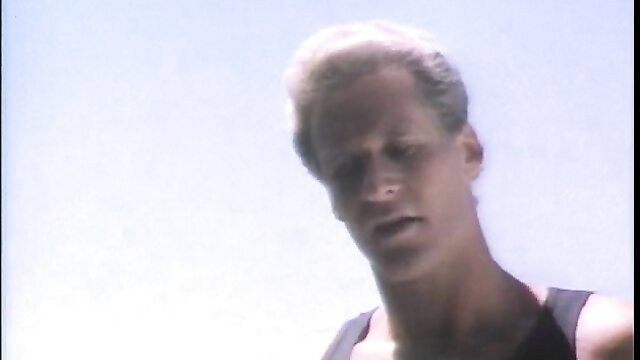 Blonde guy in tank top closeup, vintage porn thumbnail