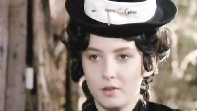 Vintage Josefine Mutzenbacher in elegant black dress and hat, seductive gaze