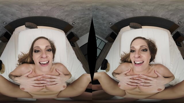 Blonde smiling POV on bed, nude tits exposed, legs spread wide open