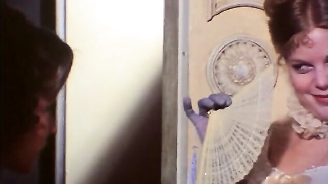 Vintage 1976 porn star in elegant gown and fan, seductive pose