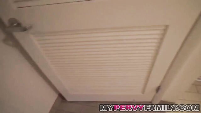 Caroline Ray bends over by door in My Pervy Family video