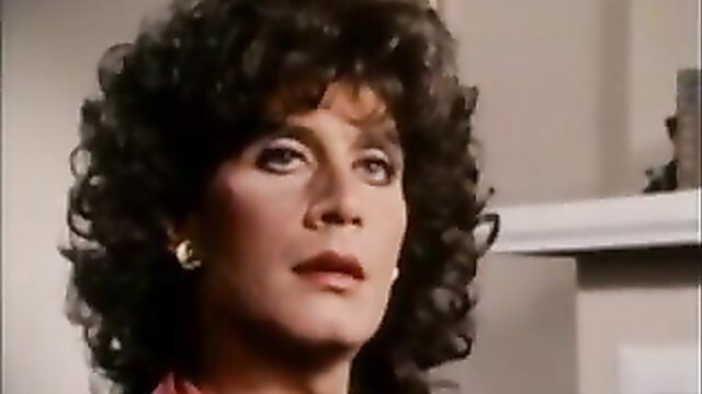 Vintage 80s brunette bombshell with big hair in sexy red dress closeup