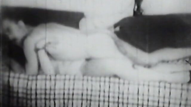 Vintage stag film nude girl lying on bed, classic American porn thumbnail