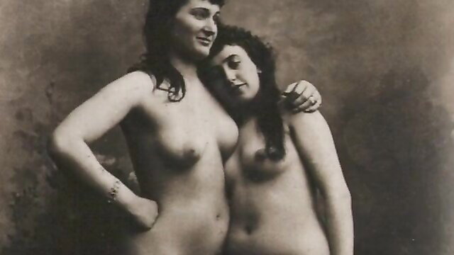 Vintage sepia nude lesbian embrace, two curvy brunettes cuddling topless
