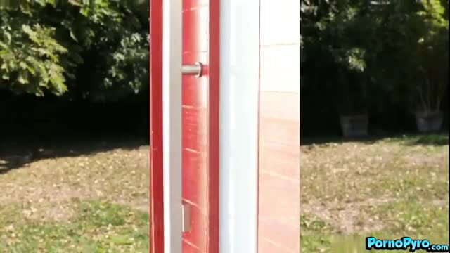 Anne Amari in red door frame, clothed outdoor scene with Ramon Nomar