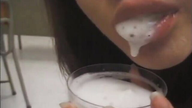 Japanese woman with cum dripping from mouth in vintage bukkake scene
