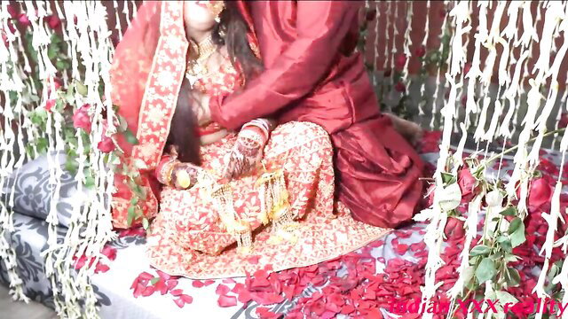 Desi Indian honeymoon couple in lehenga choli, groom groping bride