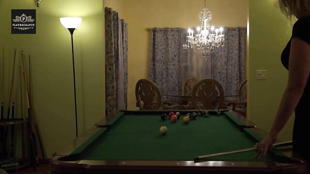 Blonde MILF bent over pool table in tight dress playing pool