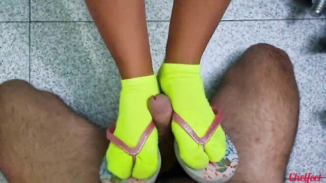Asian babe in yellow toe socks and flip flops teases cock with feet