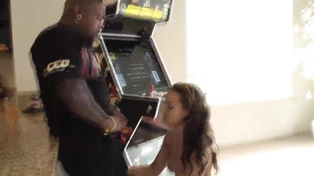 Rico Strong facefucks sexy redbone on knees by arcade cabinet