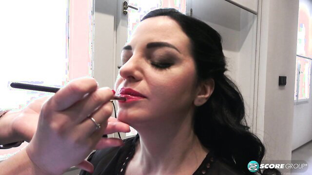 Joana Bliss getting red lipstick applied backstage at SCORE 30th Anniversary