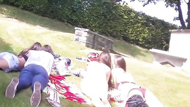 Voyeur teen girls with asses to die for lounging on grass in tight shorts