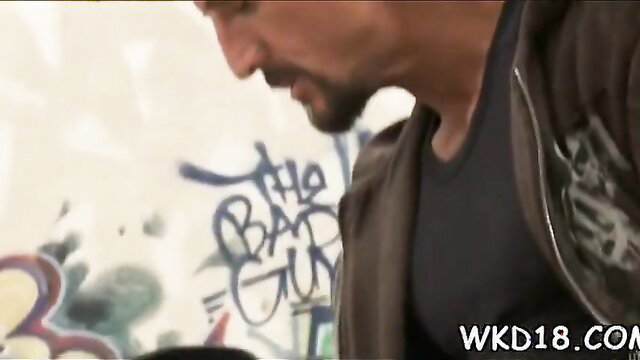 Muscular bearded man profile by graffiti wall, intense gaze