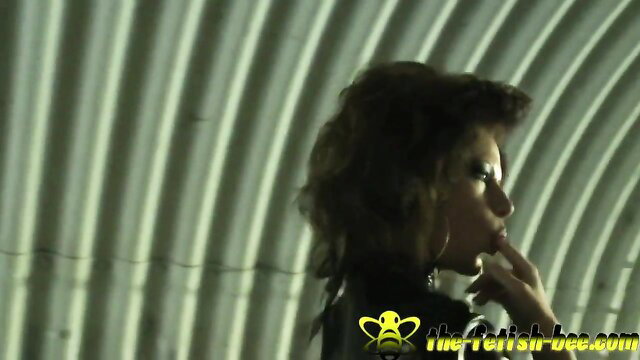 Brunette in latex skirt, high heels, outdoor tunnel tease