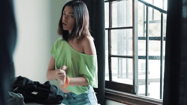 Harmony Wonder in green off-shoulder top and jeans, teasing look