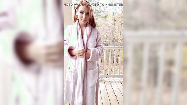 Redhead amateur babe in pink robe on balcony, getting naked outside