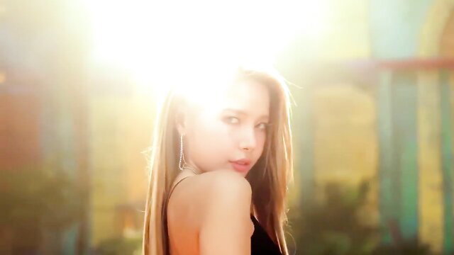 Blonde Asian beauty in black dress, golden hour glow, seductive profile view