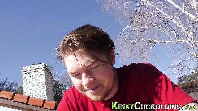 Smiling white guy with beard in red shirt on rooftop, cuckold kink