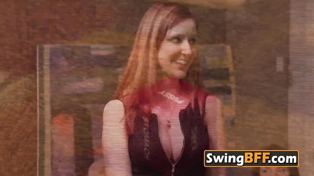 Redhead swinger in deep V lingerie smiles seductively