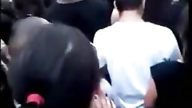 Latina beauty bent over showing off her huge round ass in public crowd