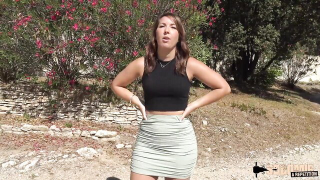 Lexie in tight black crop top and mini skirt outdoors, teasing pose