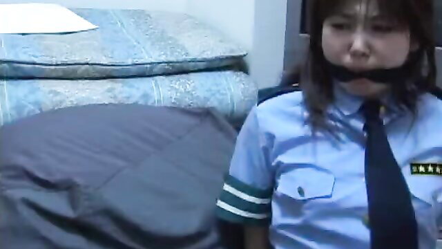 Asian policewoman bound and gagged in uniform BDSM scene