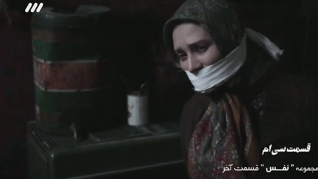 Gagged veiled Iranian woman in BDSM restraint, distressed expression