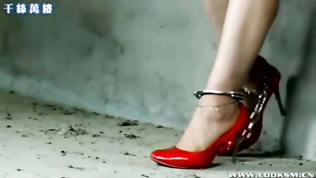 Chinese girl in red heels and ankle cuffs, outdoor BDSM bondage tease