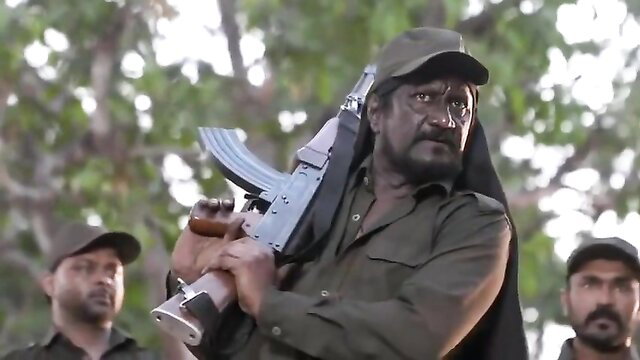 Indian cop with AK47 in intense BDSM scene, armed militant domination