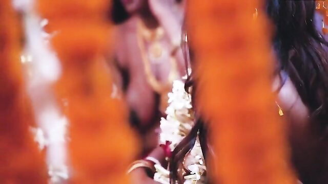 Indian bride in marigold garlands and jewelry during steamy suhagraat threesome