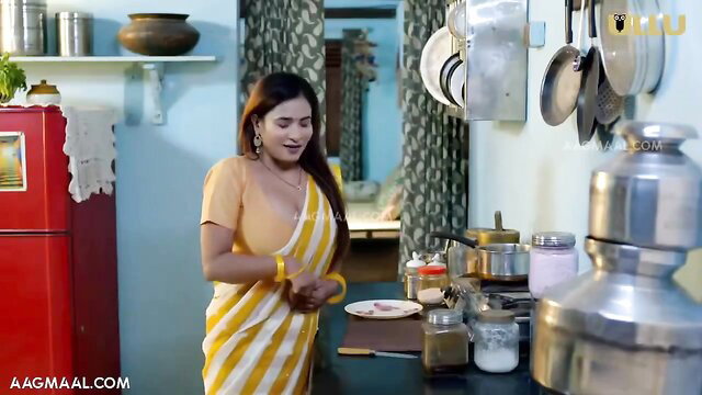 Desi Indian MILF in sheer yellow saree blouse cooking in kitchen