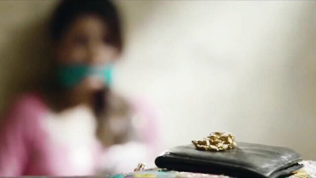 Geeta Basra gagged in bondage, blurred tease over wallet on table